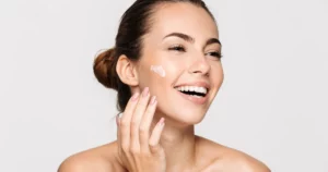 Woman applying EltaMD sunscreen to her face for daily protection in Sanford, FL
